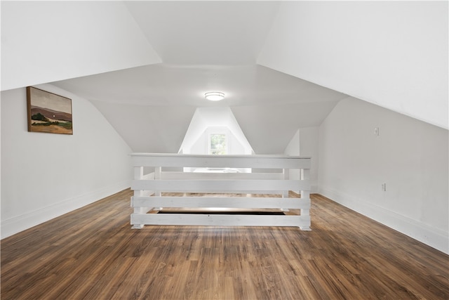 unfurnished bedroom featuring vaulted ceiling and dark hardwood / wood-style floors