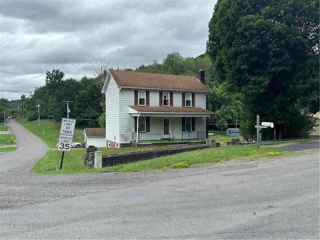 901 Clearfield Rd, Clearfield Twp, PA 16034 - view of front of property with a chimney, covered porch, and a front lawn