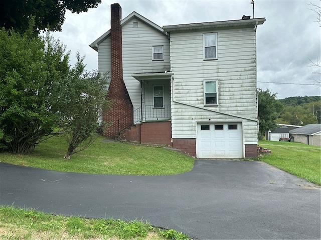 exterior space featuring a garage and a lawn