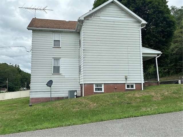 view of side of home featuring a yard