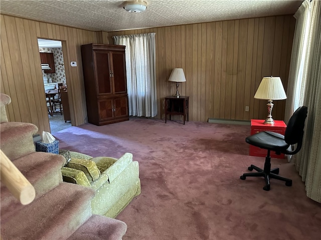 carpeted living room featuring a baseboard radiator and wood walls