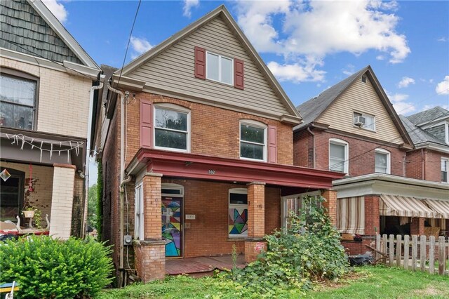 592 E 7th Ave, Tarentum, PA 15084 - view of front facade featuring brick siding and fence