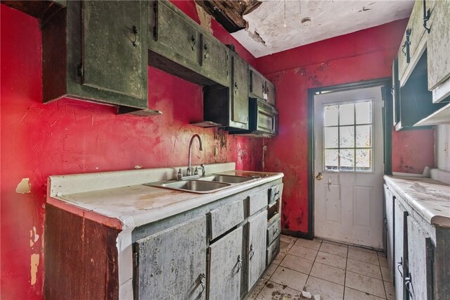 592 E 7th Ave, Tarentum, PA 15084 - kitchen featuring a sink, light tile patterned floors, light countertops, and black microwave