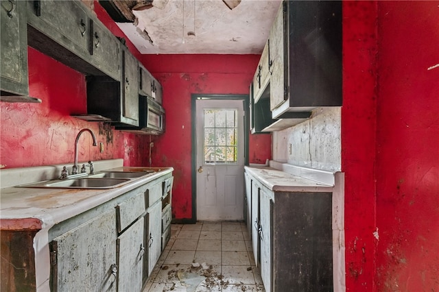 kitchen featuring light tile patterned flooring and sink