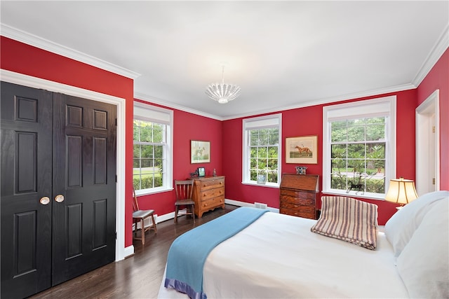 bedroom with ornamental molding, a notable chandelier, and dark hardwood / wood-style floors