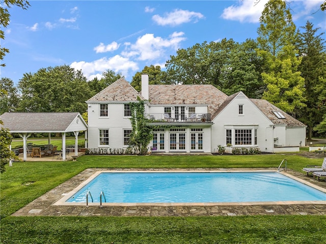 back of property featuring a patio area and a yard