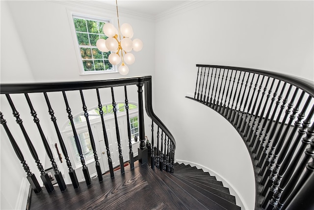 stairs with an inviting chandelier and crown molding