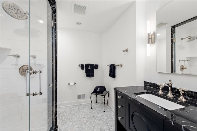 bathroom with a shower with door and vanity