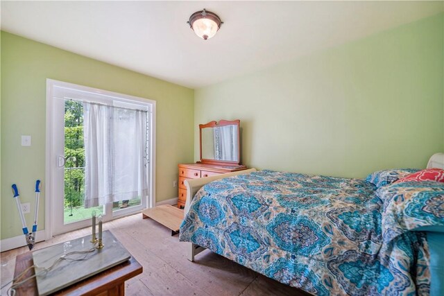 bedroom with hardwood / wood-style flooring and multiple windows