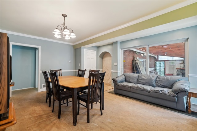 dining area with ornamental molding and a chandelier