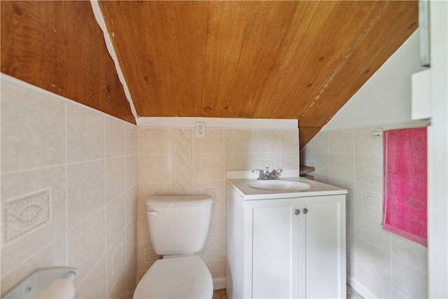 bathroom with tile walls, vaulted ceiling, and wooden ceiling