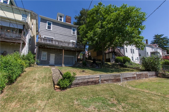 rear view of house with a yard and a deck