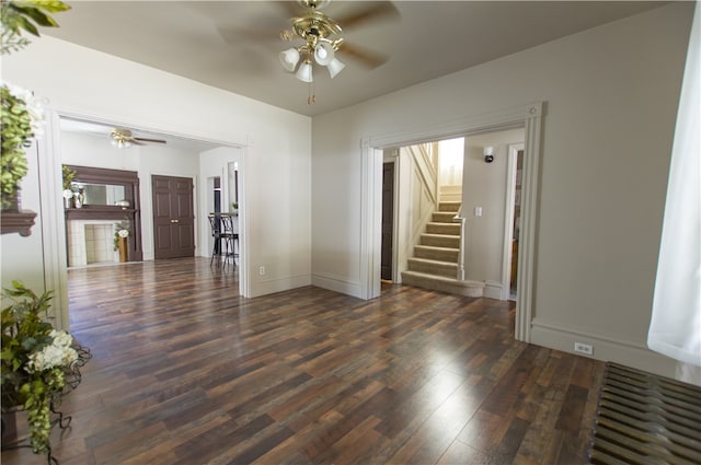 spare room featuring ceiling fan and dark wood-type flooring