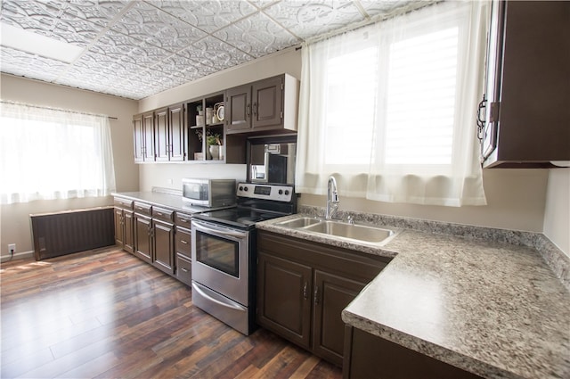 kitchen featuring appliances with stainless steel finishes, dark hardwood / wood-style floors, sink, and dark brown cabinetry