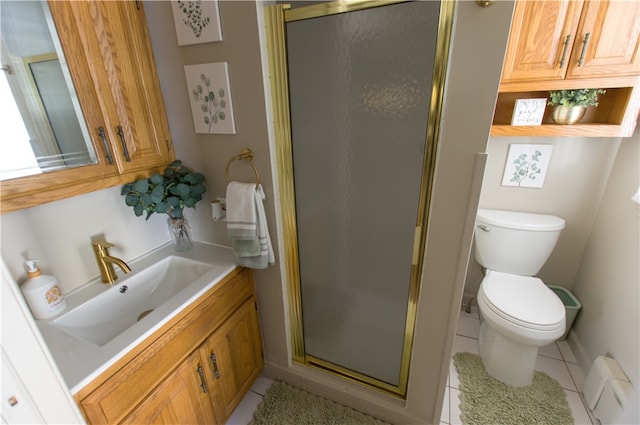 bathroom featuring walk in shower, vanity, tile patterned flooring, and toilet