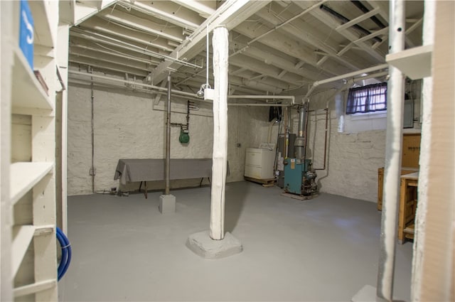 basement with heating unit and washer / clothes dryer