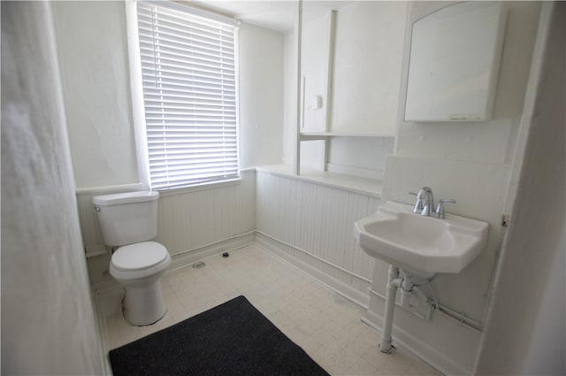 bathroom featuring sink, toilet, and tile patterned flooring