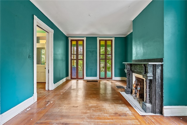 unfurnished living room with hardwood / wood-style flooring and plenty of natural light