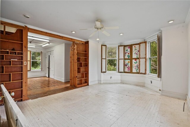 spare room featuring ceiling fan, crown molding, and light hardwood / wood-style flooring