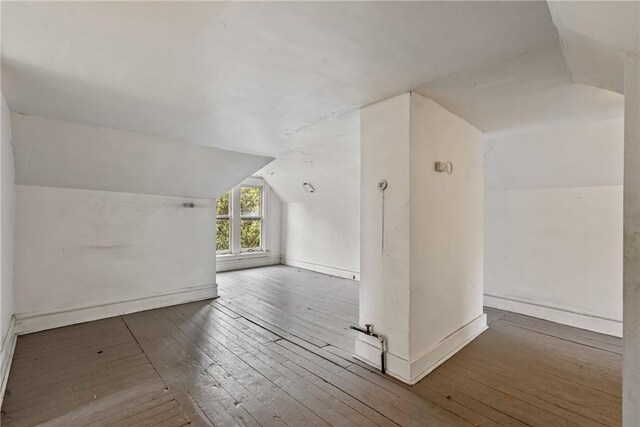 bonus room with vaulted ceiling and hardwood / wood-style floors