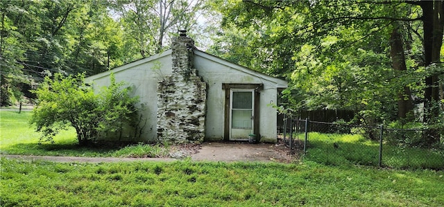 view of outdoor structure featuring a lawn