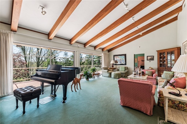 carpeted living room featuring vaulted ceiling with beams and plenty of natural light