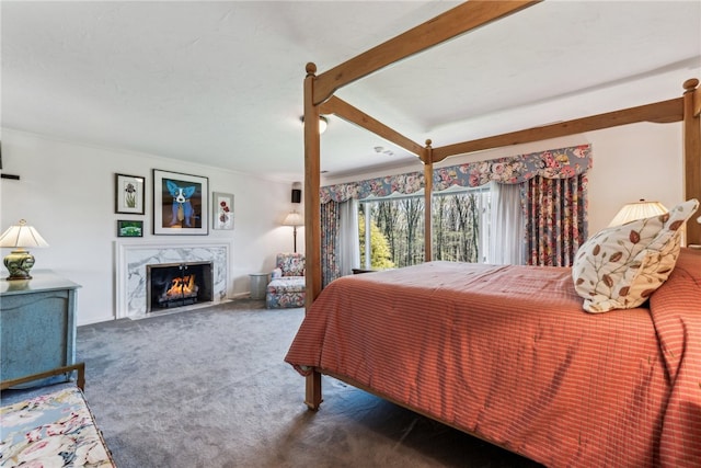 carpeted bedroom featuring a high end fireplace