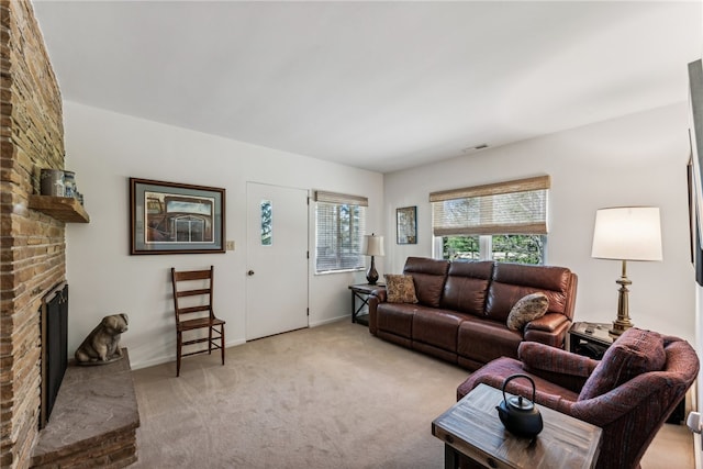 living room with light colored carpet and a brick fireplace