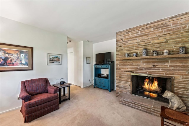 carpeted living room featuring a fireplace