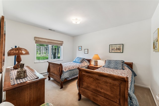 bedroom with light carpet and a baseboard radiator