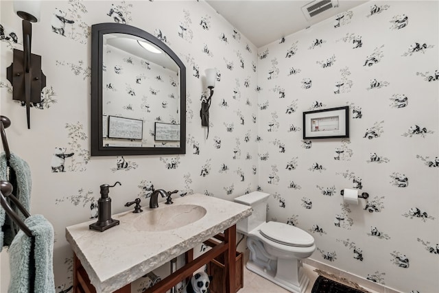 bathroom with tile patterned floors, vanity, and toilet