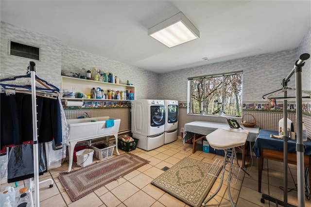 clothes washing area featuring light tile patterned floors and independent washer and dryer