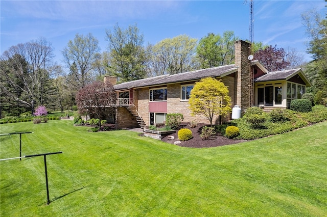 rear view of property with a lawn