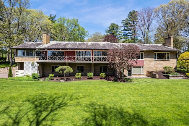 rear view of property with a yard