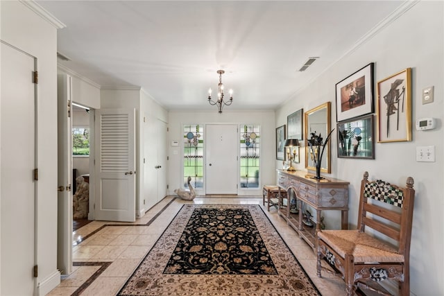 entrance foyer featuring light tile patterned flooring, ornamental molding, and a notable chandelier