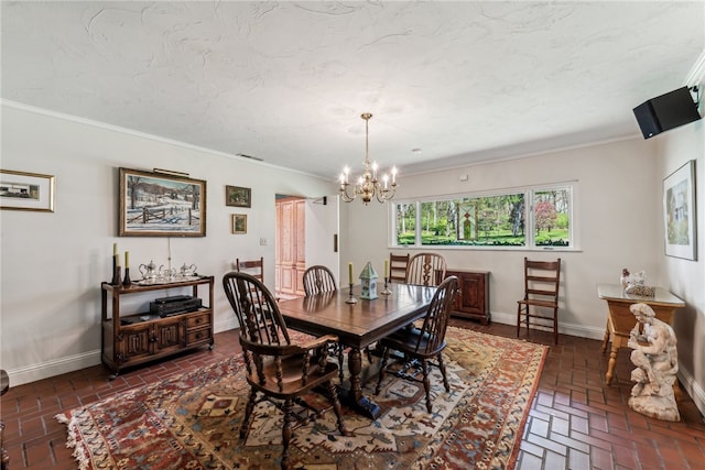 dining space with a notable chandelier and ornamental molding