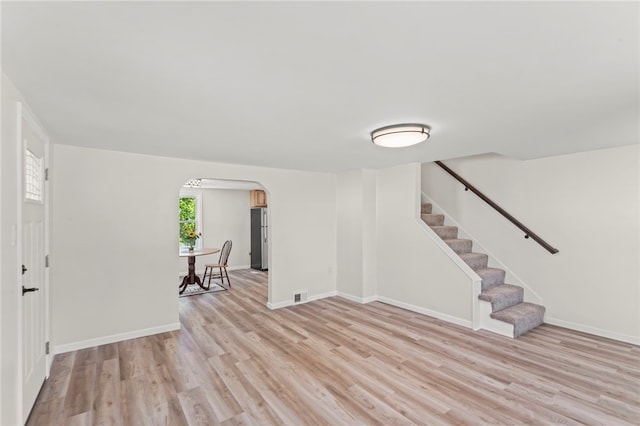 unfurnished living room with light wood-type flooring