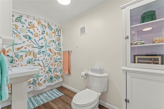 bathroom featuring toilet and hardwood / wood-style flooring