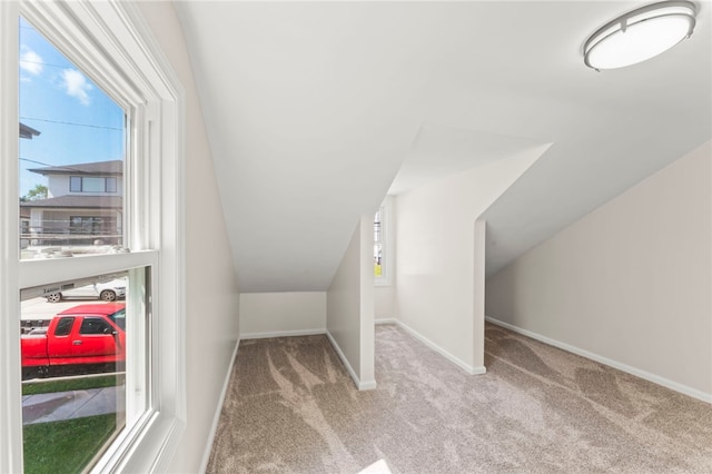 bonus room featuring carpet flooring and lofted ceiling