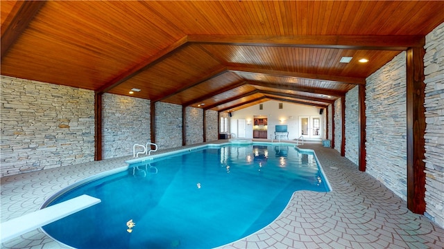 view of pool with a patio and a diving board