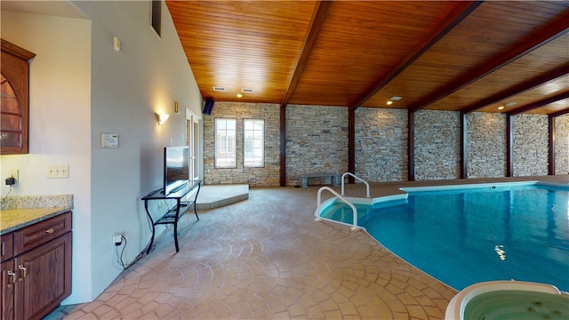 view of swimming pool with an indoor hot tub