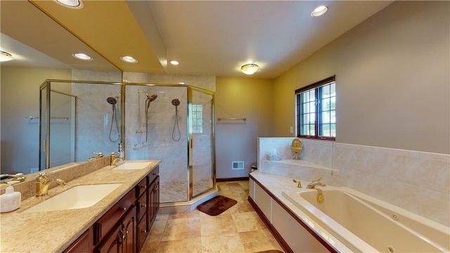 bathroom featuring shower with separate bathtub, dual bowl vanity, and tile patterned floors