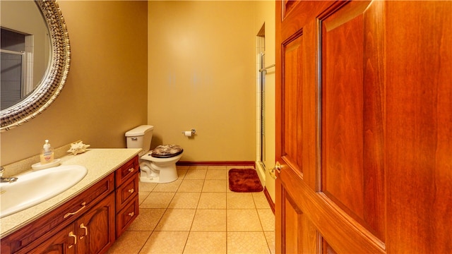 bathroom with vanity, toilet, and tile patterned flooring