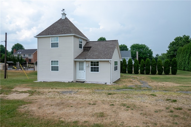 rear view of house with a lawn