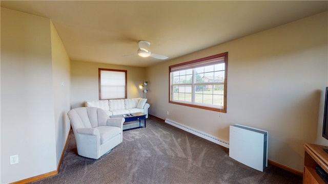 sitting room featuring a baseboard heating unit, ceiling fan, and carpet