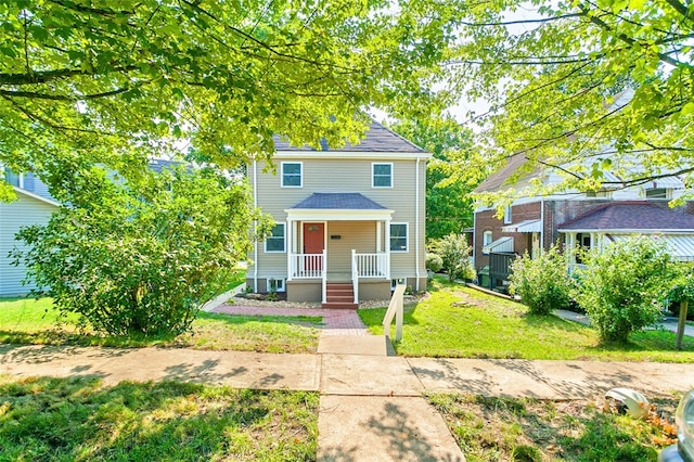 view of front of property featuring a front lawn and covered porch