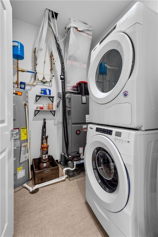 washroom featuring light carpet, stacked washer / drying machine, and water heater