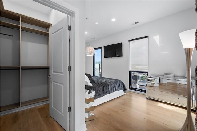 bedroom with light wood-type flooring and recessed lighting