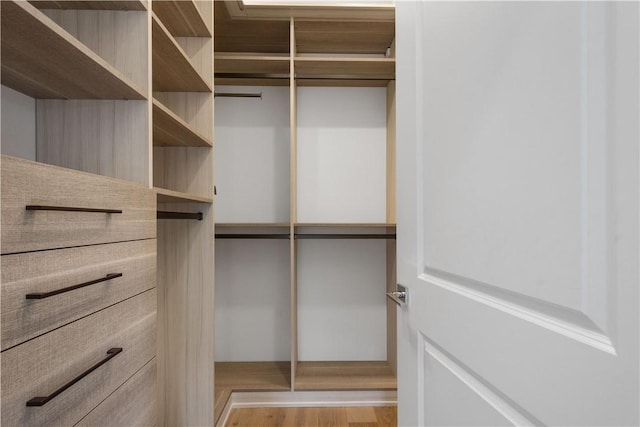 walk in closet featuring wood finished floors