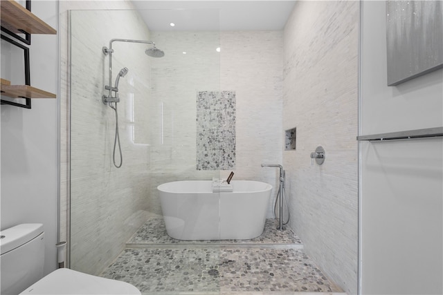 bathroom featuring shower with separate bathtub, toilet, and tile walls